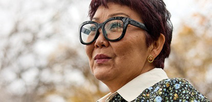 A woman with glasses looking off camera.