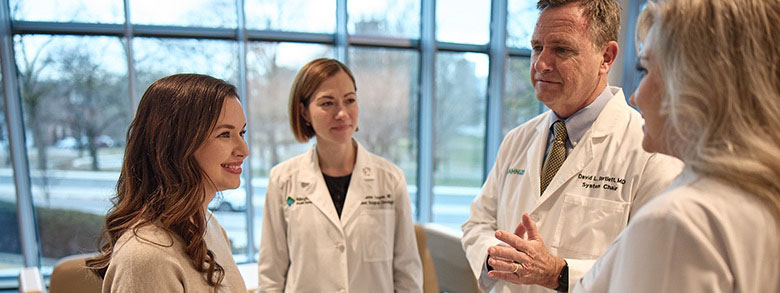 Three AHN cancer specialists talking to a patient.